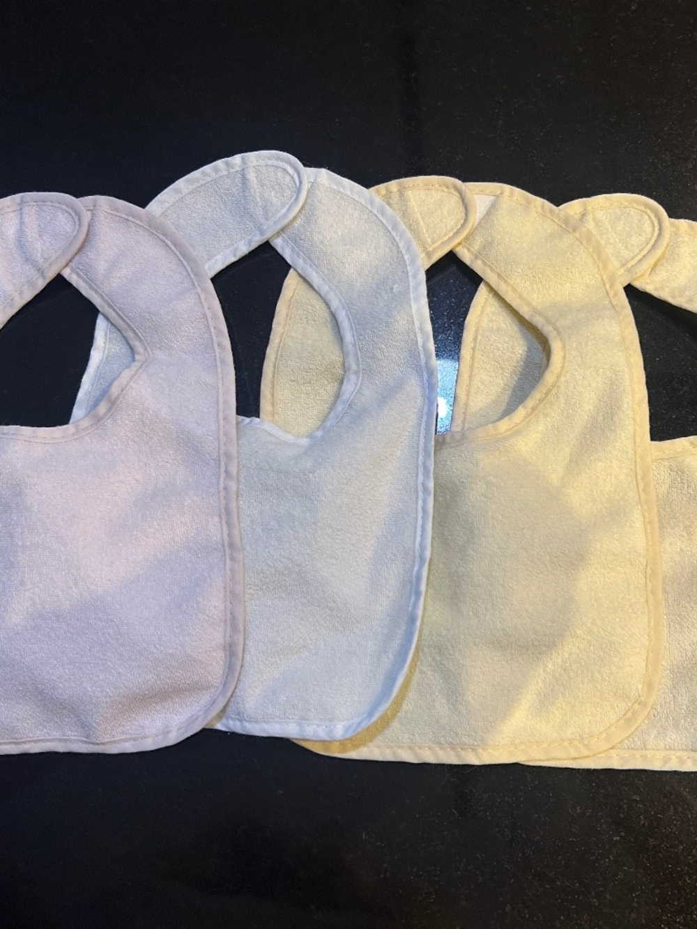 Set of four George baby bibs